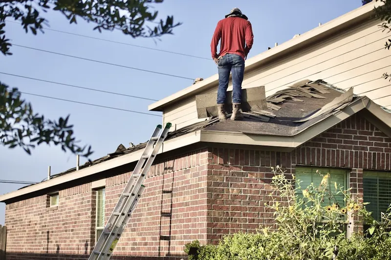 Professional roofer working on a residential roof in Fort Couch